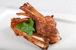 Roasted lamb on the plate and white background photo