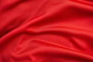 Red sports clothing fabric football jersey texture close up photo