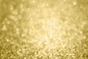 Abstract blur gold glitter sparkle defocused bokeh light background photo