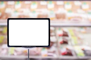 Mock up blank price board poster sign display with Abstract fresh meat shelves in supermarket grocery store blurred defocused background with bokeh light photo