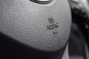 Safety airbag sign on car steering wheel with horn icon photo