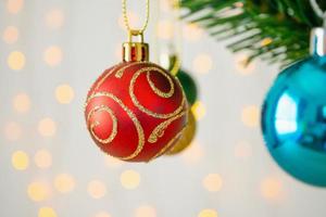 Christmas tree decorated with red ball on pine branches background photo
