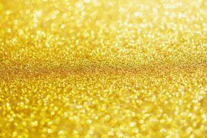 Abstract gold glitter sparkle with bokeh light background photo