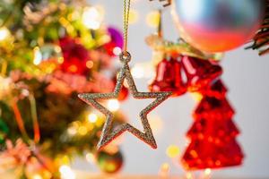 Christmas tree decorated with baubles on pine branches background photo