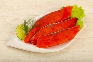 Salted salmon in a bowl on wooden background photo