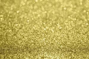Abstract blur gold glitter sparkle defocused bokeh light background photo