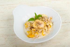 Muesli on the plate and wooden background photo