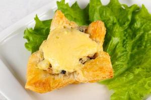 Mushroom pastry on the plate and white background photo