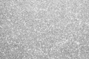 Abstract silver glitter sparkle defocused light background photo