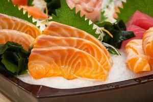 Raw salmon sashimi slice on ice Japanese food photo