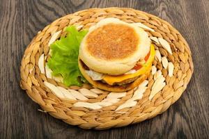 Cheeseburger on wooden board and wooden background photo