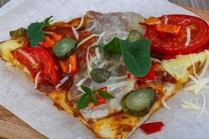 Pizza on wooden background photo