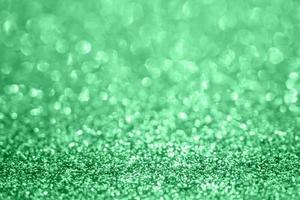 Abstract blur green glitter sparkle defocused bokeh light background photo