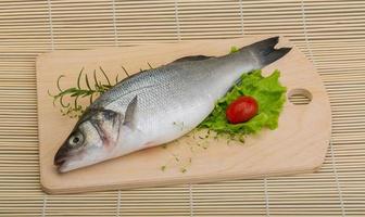 Raw seabass on wood photo