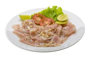 Swordfish carpaccio on white photo