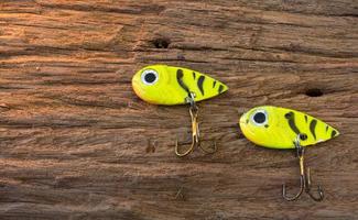 Fishing hook on wood background photo