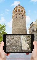 tourist photographs of Galata tower in Istanbul photo