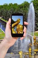 tourist taking photo of Samson Fountain