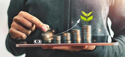 Startup concept with icon business and network connection with people putting coins stack  and plant growth on money photo