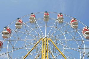carnival, Ferris wheel over blue sky in amusement park in summer photo