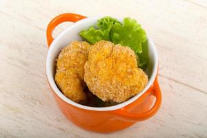 Crispy cauliflower in a bowl on wooden background photo