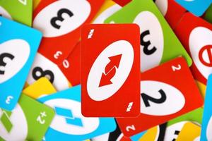 TERNOPIL, UKRAINE - MAY 15, 2022 Many colorful UNO game cards. UNO is an American shedding-type card game that is played with a specially printed deck photo