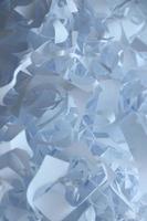 Shredded paper texture background, top view of many white paper strips. Pile of cut paper like box filler for shipping fragile items photo