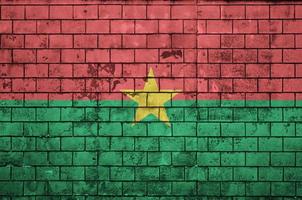 Burkina Faso flag is painted onto an old brick wall photo