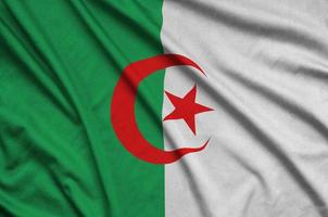 Algeria flag  is depicted on a sports cloth fabric with many folds. Sport team banner photo