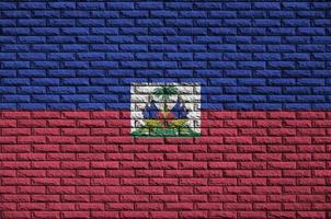 Haiti flag is painted onto an old brick wall photo