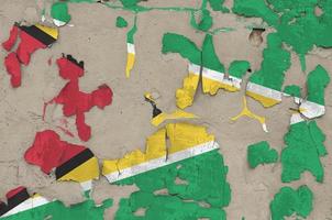 Guyana flag depicted in paint colors on old obsolete messy concrete wall closeup. Textured banner on rough background photo