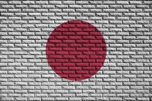 Japan flag is painted onto an old brick wall photo