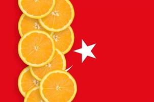 Turkey flag and citrus fruit slices vertical row photo