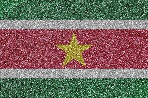 Suriname flag depicted on many small shiny sequins. Colorful festival background for party photo