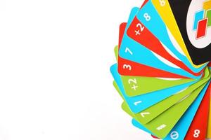TERNOPIL, UKRAINE - MAY 15, 2022 Many colorful UNO game cards on white background. UNO is an American shedding-type card game that is played with a specially printed deck photo