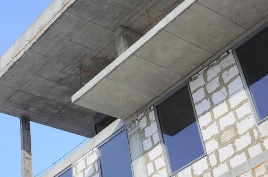 Fragment of an unfinished structure of a multi-storey building made of large concrete bricks photo