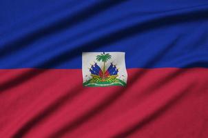 Haiti flag  is depicted on a sports cloth fabric with many folds. Sport team banner photo