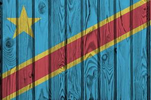 Democratic Republic of the Congo flag depicted in bright paint colors on old wooden wall. Textured banner on rough background photo