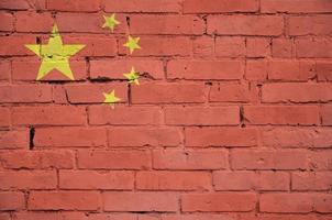 China flag is painted onto an old brick wall photo