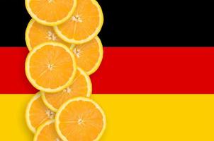 Germany flag and citrus fruit slices vertical row photo