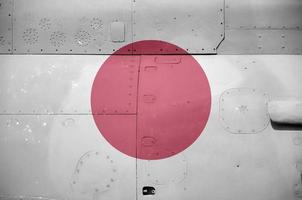 Japan flag depicted on side part of military armored helicopter closeup. Army forces aircraft conceptual background photo