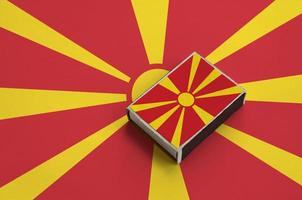 Macedonia flag  is pictured on a matchbox that lies on a large flag photo