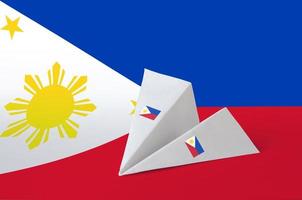 Philippines flag depicted on paper origami airplane. Handmade arts concept photo