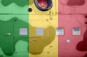 Mali flag depicted on side part of military armored helicopter closeup. Army forces aircraft conceptual background photo