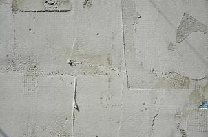 The texture of the wall, covered with gray foam polystyrene plates, which are smeared with a reinforcing mixture. Stage of wall insulation photo