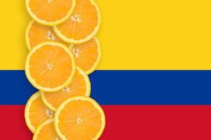 Colombia flag and citrus fruit slices vertical row photo