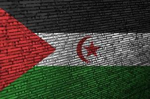 Western Sahara flag  is depicted on the screen with the program code. The concept of modern technology and site development photo