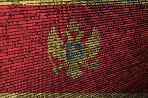 Montenegro flag  is depicted on the screen with the program code. The concept of modern technology and site development photo