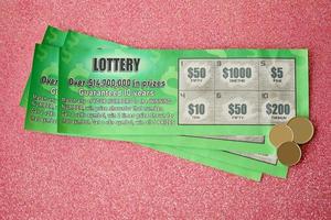 Close up view of green lottery scratch cards. Many used fake instant lottery tickets with gambling results. Gambling addiction photo