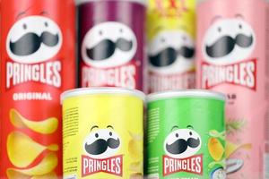 KHARKIV, UKRAINE - DECEMBER 16, 2021 Pringles product with new logo. Pringles is a brand of potato snack chips owned by the Kellogg Company photo